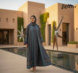 Elegant Grey Embroidered Open Abaya with Geometric Borders A0006 worn by a woman in an outdoor modern setting.