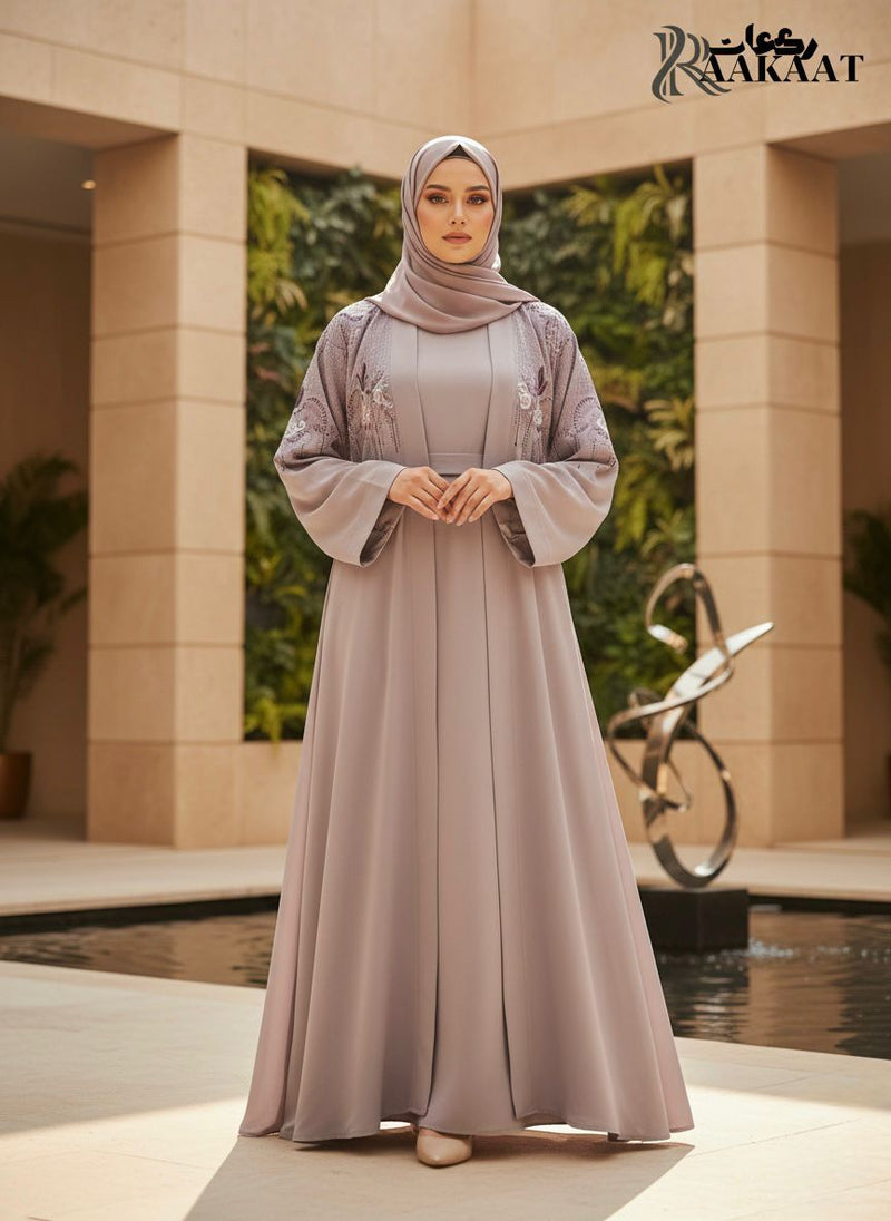 Elegant model in a lavender Premium Abaya, showcasing intricate embroidery in an outdoor setting.