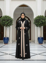 White Embroidered Abaya 🤍 A0002 showcased in a luxurious setting, featuring floral embroidery and a stylish hijab.