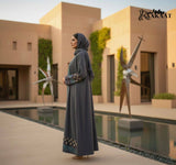 Elegant Grey Embroidered Open Abaya with Geometric Borders A0006 worn by a model in an outdoor setting.