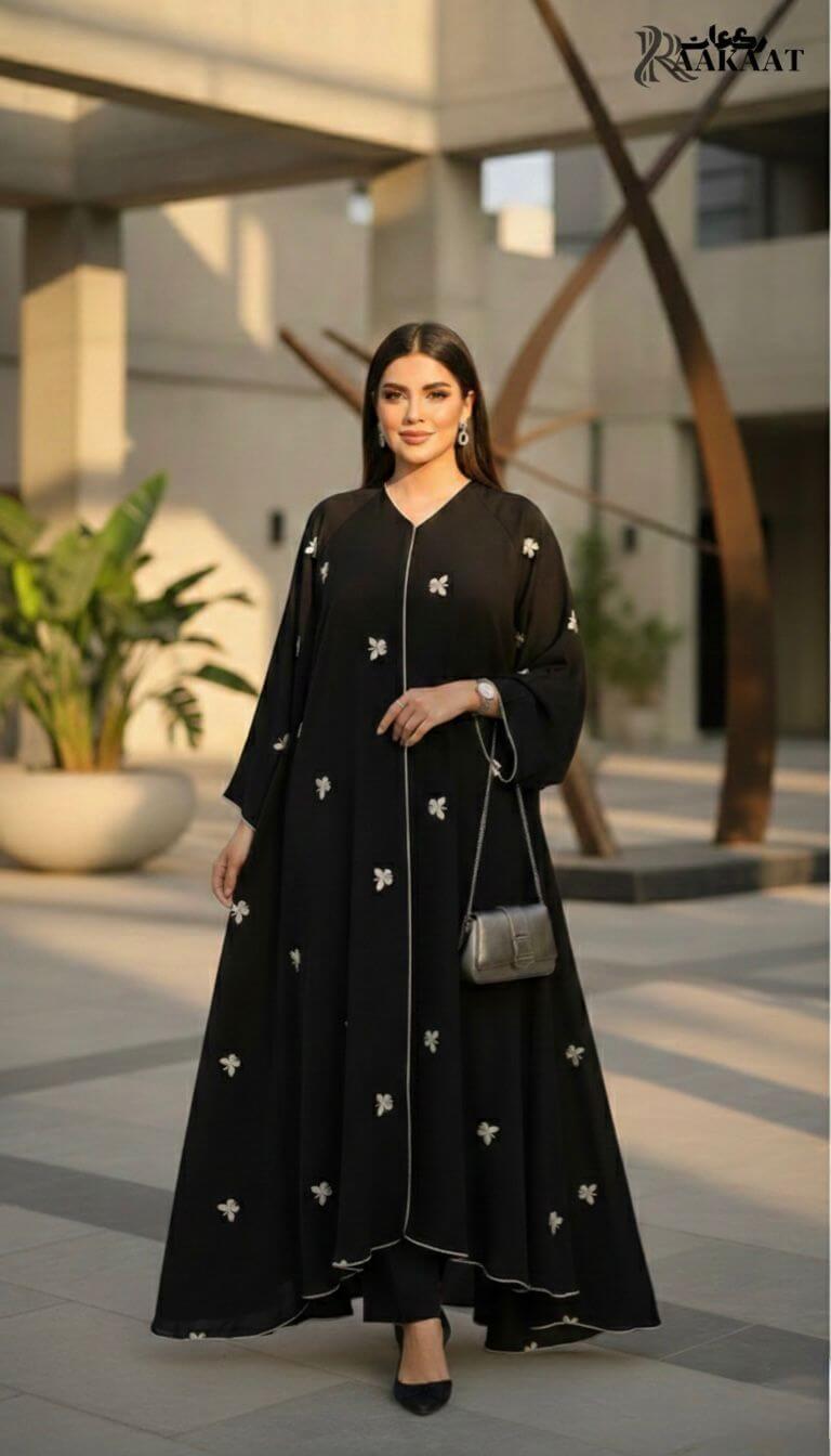 Classic Black Butterfly Embroidered Open Abaya with Contrast Piping  A0007 worn by a model in a modern setting.