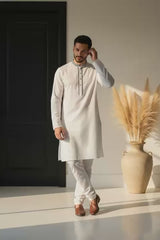 Ivory Noor – Minimalist Bangladeshi Panjabi P0004 worn by a model in a modern setting with decorative elements.