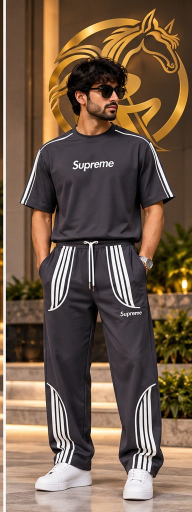 Men's charcoal matching T-shirt and jogger pants set lifestyle model photo with gold Raakaat icon in background